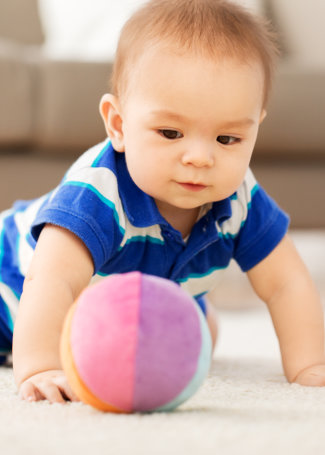 baby boy playing with toy ball