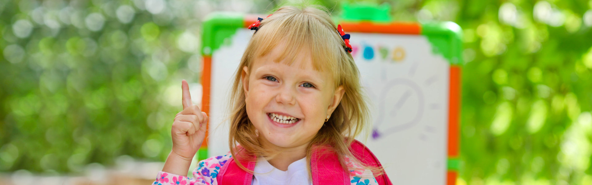 Little school girl with a backpack.
