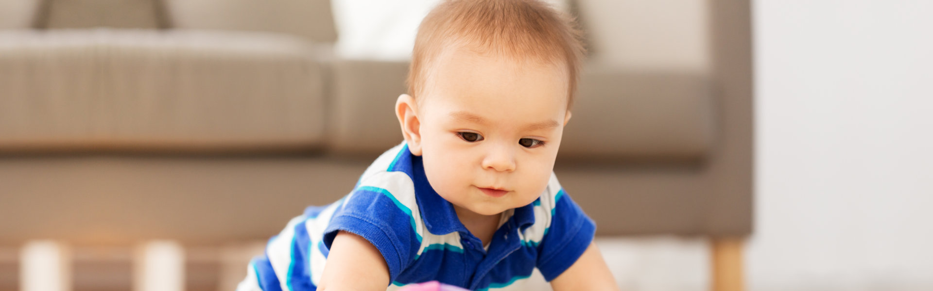 baby boy playing with toy ball