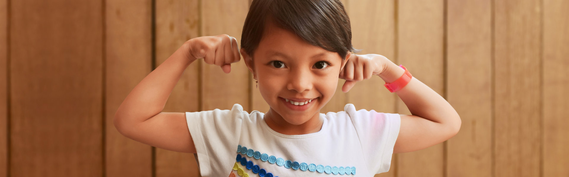 little girl showing muscles