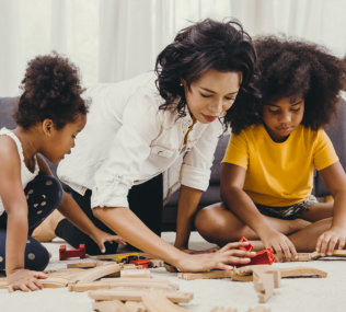 Person helping children playing